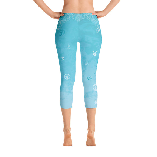 Om Shanti sky blue capri leggings with om signs, peace signs, mantras and stylized art. Great for yoga and gym workouts! Designed by Sushila Oliphant, Apparel for the Spirit.